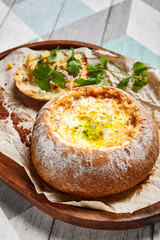 Cheese soup served in round bread loaf