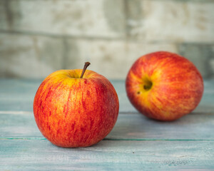 Two chicken red-yellow apples on a wooden table