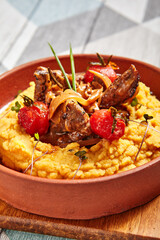 Hummus with beef served in brown bowl