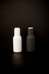 Black and white vases at the dark background