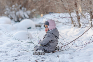 Cute child playing with snow