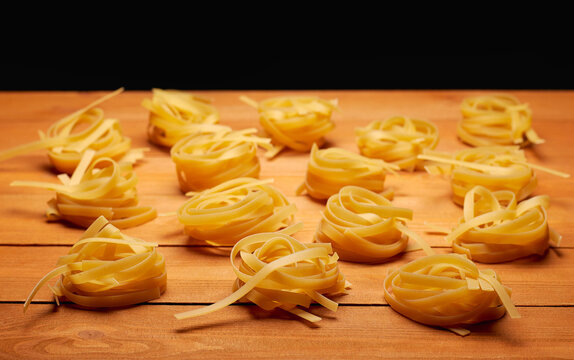 Raw uncooked pasta on the homemade wooden table
