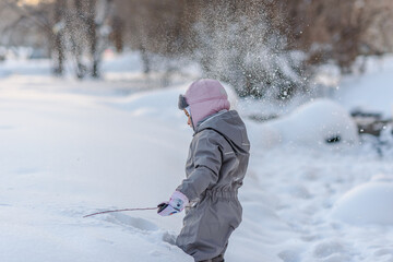 Cute child playing with snow