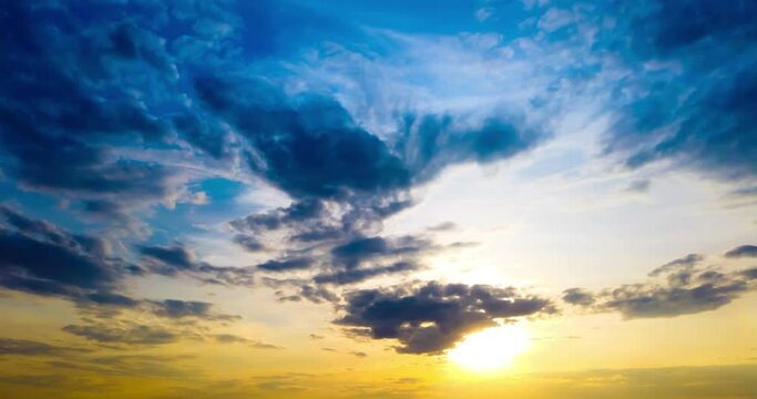Time lapse of sunset sky and clouds with moving sun on blue sky background. Timelapse 4K clip