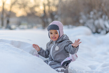 Fototapeta na wymiar Cute child playing with snow