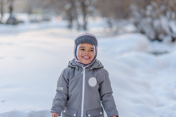 Cute child playing with snow