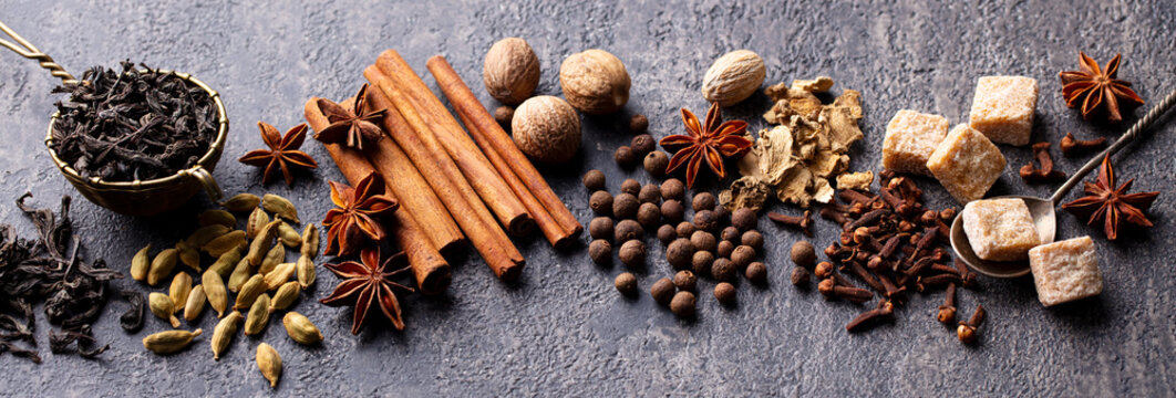 Spices for Indian masala tea. Grey background. Close up.