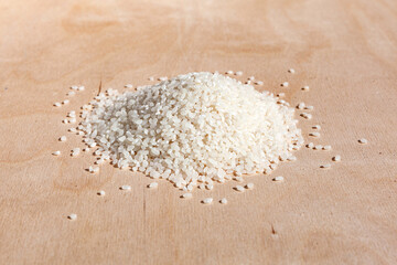 Raw white round grain rice. Rice in a pile. Groats for making rice porridgerice on a wooden background.Raw product. Harvest day. Food ingredient