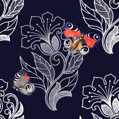 Fototapeta premium White openwork with butterfly on blue background. Floral seamless pattern.