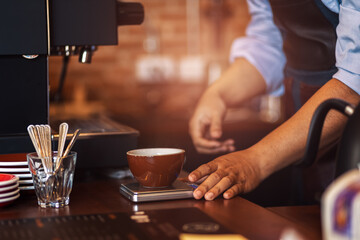 Fototapeta na wymiar Barista and Measuring coffee cup at coffee shop.