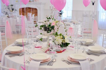 Pink balloons and beautiful decorated tables for a party dinner