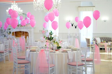 Pink balloons and beautiful decorated tables for a party dinner