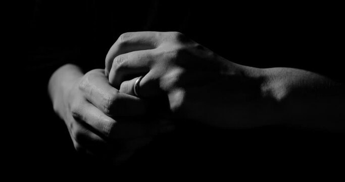 Fingers twirl the wedding ring, abstraction