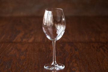 Empty wine glass on the dark wooden table