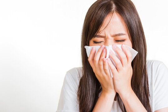 Portrait Of Asian Beautiful Young Woman Sad She Crying Wipe The Mucus With Tissue, Close Up Of Pretty Girl Sneezing Sinus Using Towel To Wipe Snot From Nose, Studio Shot Isolated On White Background