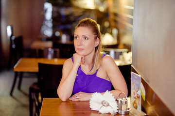 Young stylish beautiful woman walking in street, wearing dress and jacket, fashion outfit, spring and summer trend.