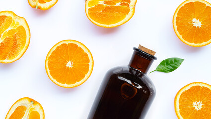 Natural orange essential oil on white background.