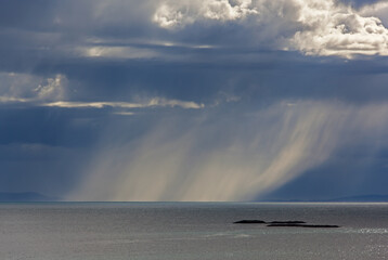 Rain over the Barents sea illuminated by the sunlight, Finnmark, Norway
