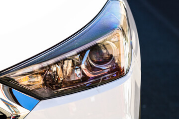 Close up photo of modern car, detail of headlight. Headlight car Projector LED of a modern luxury...