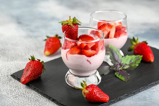 Dessert with fresh strawberry, ricotta, strawberry jam and basil on glasses