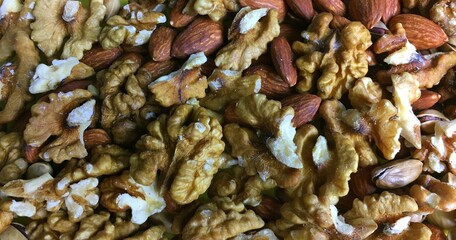 plate with almonds, pistachios and walnuts, vegetarian food, snacks, close-up view from above