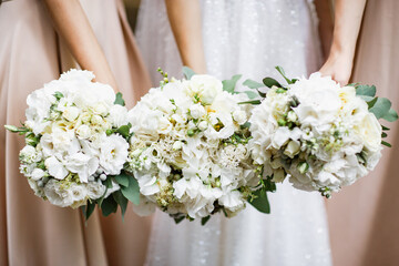 Wedding bouquets holding in hands.