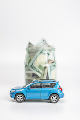 Miniature car model and Financial statement with coins. Finance and car loan, saving money for a car or material design concepts.