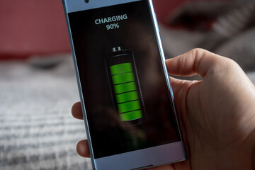 wireless smartphone charging concept, full green battery icon on a phone screen