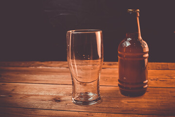 Glass of cold pale beer placed on a rustic wooden table