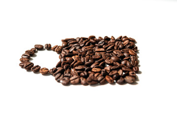 roasted coffee beans in the shape cup on white background. side view.