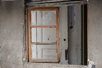 Window of an empty abandoned old building with broken glasses