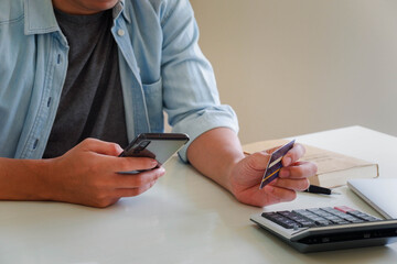 Hands holding credit card and using laptop. Online shopping
