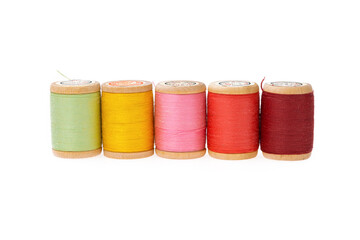 Colorful thread on a wooden spool. Isolated bobbins. White  isolated background. Retro style bobbins. Close up