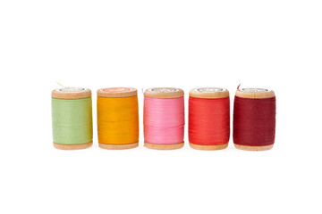 Colorful thread on a wooden spool. Isolated bobbins. White  isolated background. Retro style bobbins. Close up