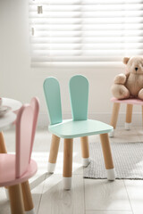 Cute little chair with bunny ears indoors. Children's room interior