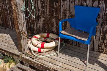Fototapeta na wymiar lifebuoy and chair in a fisherman's hut in Algarve