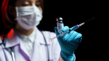 Doctor hand holding coronavirus vaccine shot for diseases outbreak vaccination, medicine and drug...