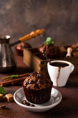 Chocolate muffins with a cup of coffee on the table