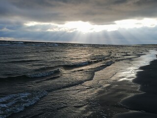 Rays of sun over the sea cloudy skies