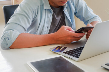 Hands holding credit card and using laptop. Online shopping