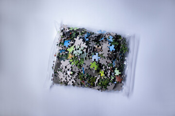 packing with multicoloured puzzles on a white background. isolated. High quality photo
