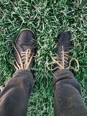 Shoes in frost covered grass