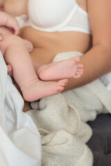 Fototapeta na wymiar Feet of new born Baby in Hands of parents