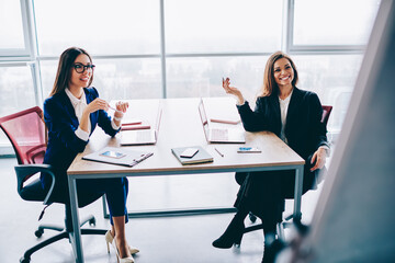 colleagues discussing ideas and talking in office interior, brainstorming meeting