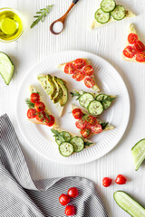 green avocado toasts on white background from above pattern