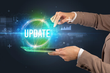 Obraz premium Close-up of a touchscreen with UPDATE inscription, new technology concept