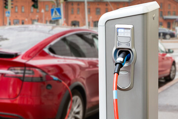 Fototapeta na wymiar Charging station on the background of an electric car.