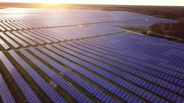 aerial view of solar panels on green lawn. drone shot, bird's eye. 4K