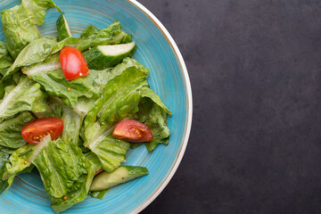 Close-up top view, fresh vegetable salad with fresh ingredients. Vegetarian lunch. Breakfast with salad. Country style. Vegetable stew. Lenten snacks. An empty breakfast. Light spring vegetable salad.