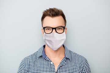 Close-up portrait of his he attractive content guy wearing reusable cotton textile mask health care stay home keep social distance disease prevention isolated over grey light pastel color background